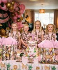 Children with Pink Deer Camo Gift Bag Set with tissue paper and greeting card at woodland themed birthday party decor.