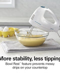 Hamilton Beach 6 Speed Electric Hand Mixer With Quick Burst And Bowl Rest in action mixing batter in a glass bowl.