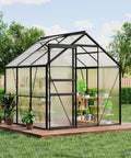 Outdoor view of a Six By Six Foot Greenhouse Kit with aluminum frame and polycarbonate panels, showing vent and lockable door in garden setting.
