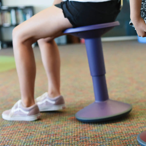 Person using SitWell Wobble Stool With Adjustable Height For Active Seating And Core Engagement, Eggplant Purple Classroom Chair