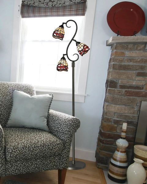 Three Light Floor Lamp With Hand Rolled Art Glass Shade In Dark Bronze Finish, Fall River Collection in a living room corner