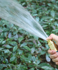 Five Eighths Inch Garden Hose Connector Repair Fittings Set in use spraying water over green plants