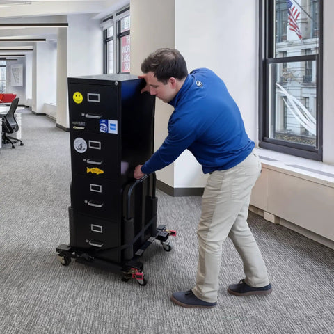 Man using Anderson Dolly Adjustable Heavy Duty Moving System, 1600 Lb Capacity to move a filing cabinet in an office.