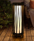 Outdoor Solar Floor Lamp With Rattan Trim And Steel Frame, Waterproof Patio Lantern on wooden deck at night