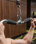 Person using Lat Bar Cable Machine Attachment With Full Rotation Rubber Grip 30 Inch Pulldown Bar in gym setting