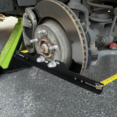 Pro Grade Wheel Alignment Tool Kit With Tape Measures, Heavy Duty Toe Alignment Plates installed on car wheel hub.