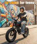 Teen riding Beast 1200W Fat Tire Electric Mountain Bike by colorful art wall, helmet worn, urban street setting.
