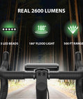 Lit Ultra Bright 2600 Lumen Bike Light Set for Night Riding showing handlebars, LED features, and range at night