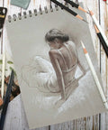 Artist's sketch on gray paper with Three Pack White Charcoal Pencil Set For Drawing Sketching Shading Blending And Highlights On Dark Paper Top Notch Pro Grade Quality For High Contrast Artwork And Easy Light Accents, showing a woman sitting.