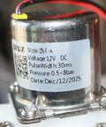 Close-up of model ZNF-A 12V DC solenoid valve with label showing voltage, pulse width, and pressure for smart toilet bidet installation.