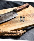 Top Tier Flat Head Knife Handle Screws Coupled With Heavy Gauge Stainless Steel Bolts on a wooden cutting board.