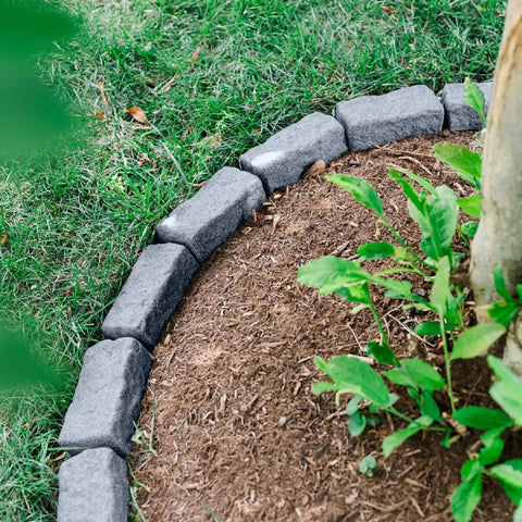 Greystone Faux Stone Landscape Edging Kit for Lawn and Garden Borders 40 Pack, shown bordering a tree area with grass and mulch.