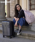 BAGSMART expandable carry-on luggage, gray polycarbonate hard-shell with 4 spinner wheels; pink backpack.