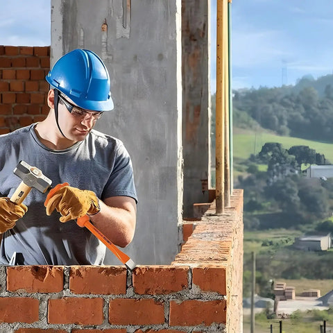 Worker using Beefy 12-Inch Flat Chisel With Bi-Material Hand Guard for demolishing masonry carving, heat-treated CRV steel visible