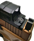 Close-up of Glock MOS Adapter Plate Screw Kit 28 Piece Set with carbon steel screws and optic attached to a pistol slide.