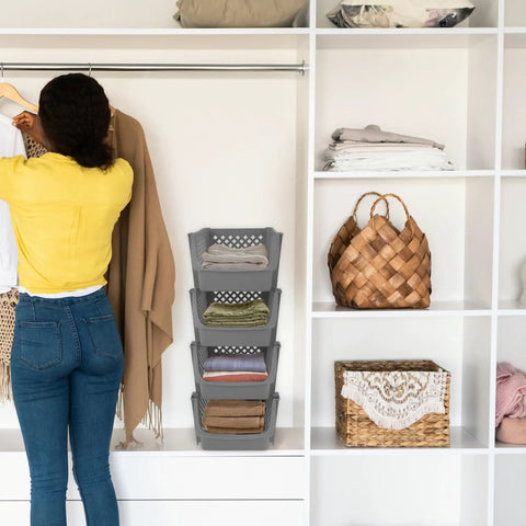 Woman organizing clothes in closet with Stackable Plastic Storage Bins 4 Piece Gray Set For Home And Kitchen Open Front Design