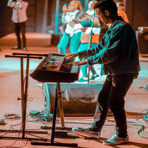 Musician performing with digital piano and Universal Sustain Pedal For Digital Pianos And MIDI Keyboards With Quarter Inch Jack And Polarity Switch Plug And Play Ready Compatible With Electronic Organs Synthesizers Keyboard Controllers And Electric Pianos on stage