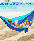 Children relaxing in Blue Outdoor Camping Hammock Portable With Tree Straps And Rope, 56 By 103 Inches, on beach