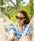 Woman relaxing in Caribbean Hammock Chair With 40-Inch Hardwood Spreader Bar And Soft-Spun Cotton Rope, Indoor Outdoor Chill Lounger