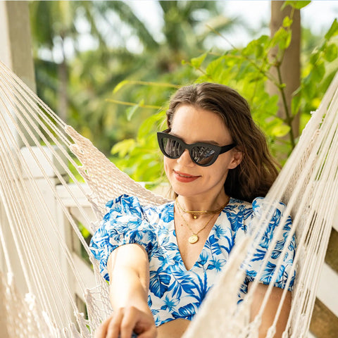 Woman relaxing in Caribbean Hammock Chair With 40-Inch Hardwood Spreader Bar And Soft-Spun Cotton Rope, Indoor Outdoor Chill Lounger