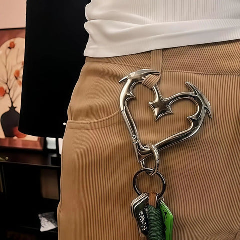 Person wearing edgy Gothic Keychain with Cute Carabiner Clip on side of beige pants, showcasing Y2K fashion accessory for keys.