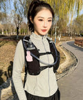 Person wearing Hydration Vest Water Backpack For Running And Hiking Lightweight Reservoir Pack With Breathable Back Panel
