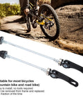 Pair Of Quick Release Bike Skewers QR For MTB And Road Bikes Front 150mm And Rear 190mm on ground with bicycle in background.
