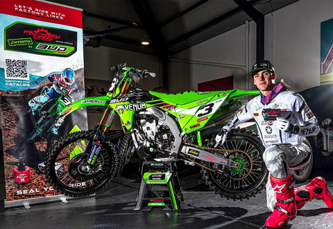 Motocross rider next to green Kawasaki bike highlighting Rear Wheel Bearing Kit for Kawasaki KX125 KX250 KX500 1997 to 2004 OEM Quality Bearings and Seals Direct Fit Heavy Duty Hub Load Ready Durable Cost Effective Replacement for Trail and Track Riders.