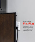 UltraPro 10 Outlet Surge Protector with USB Charging plugged into wall with low-profile flat plug behind furniture.