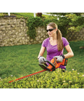 Person using 40V Max Hedge Trimmer With 22 Inch Dual Action Blade Low Vibration for Smooth Cuts Up To Three Quarters Inch Thick