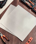 6061 Aluminum Sheet Set, 2 Pieces, 15x15 Inch Flat Stock, One Eighth Inch Thick, Protective Film Covered Plates, with tools around