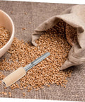 Stainless Steel Grain Sampler With Wooden Handle For Wheat And Rice Sampling next to bowl and sack of wheat on burlap