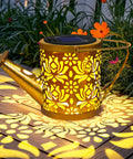 Cool Solar Watering Can With Lights For Outdoor Decor, copper coin pattern casting warm patterns with 50 LED fairy lights in a garden.