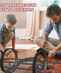 Father and son playing with Dope 32Ft Electric Powered Slot Car Race Track Set With Four High Speed Cars And Dual Hand Controllers