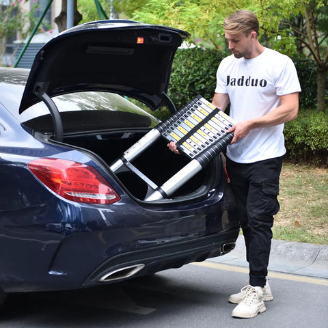 Person placing Aluminum Telescoping Ladder 16 Point 5 Feet Extension With Triangle Stabilizers into car trunk for easy transport