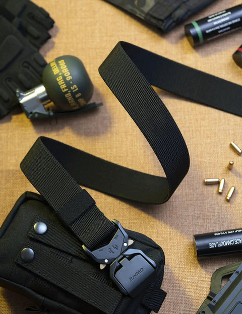 Rugged 1.5 Inch Nylon Tactical Belt With Quick Release Aluminum Buckle shown with outdoor gear on brown surface