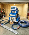 Pro Upgrade Polyurethane Foam Spray Gun Machine Dual Component Proportioning System in a garage with hoses and tools.