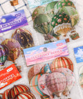 120 Colorful Hot Air Balloon PET Stickers Set for Scrapbooking and Journaling, Waterproof DIY Craft Decor displayed in packaging.