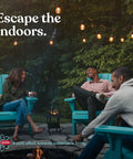 Three people enjoying an evening on a patio with string lights and blue chairs, promoting outdoor living.