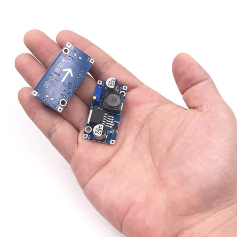 Person holding 10 Pack LM2596 DC Buck Converter Step Down Module Power Supply Adjustable 1.25V To 30V Output Up To 3A DIP