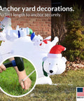 Person securing inflatable with 30 Pack Tent Stakes 9 Inch Galvanized Steel Ground Spikes With 1 Inch Hook Built Tough Rust Resistant 8 Gauge For Tents Fences Tarps Decorations Inflatables Outdoor Use Made In USA, image showing hand hammering stake into ground next to polar bear decoration.