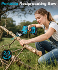 SEESII cordless reciprocating saw being used to cut a branch, teal/black with battery pack
