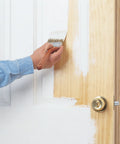 Hand applying Bullseye 1-2-3 Plus Primer Go-To Interior Exterior Oil Based Sealer on wooden door with paintbrush