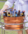 Woman carrying Insulated Rose Copper Double Wall Ice Bucket For Parties And Entertaining, Leak Proof Champagne And Wine Cooler With Sturdy Handles