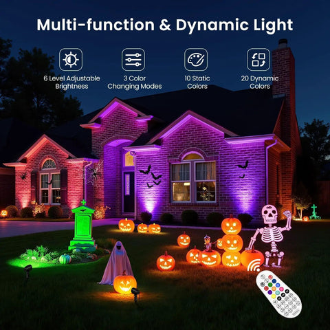 Colorful Halloween display using 8 Pack RGBW Low Voltage Landscape Lights Kit with 100W Transformer, remote control visible.