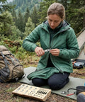 Person using Three In One Zipper Repair Kit With Anti Slip Lock Sliders And Replacement Pulls in a campsite setting