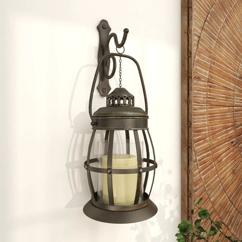 Rustic Metal Wall Sconce Lantern With Suspended Pillar Design Brown Glass Finish For Farmhouse Boho Eclectic Interiors Vibe 7 Inch By 10 Inch By 19 Inch Wall Mount Light, showing candle holder against wall.