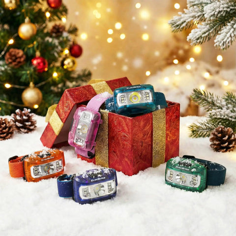 Five Pack Kids Headlamps With Red Light And Memory Function, assorted colors, in open gift box surrounded by snow and holiday decor