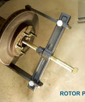 Heavy Duty Hub Drum And Rotor Puller Kit For Impact Wrench Removal in use on brake rotor showing forged construction.