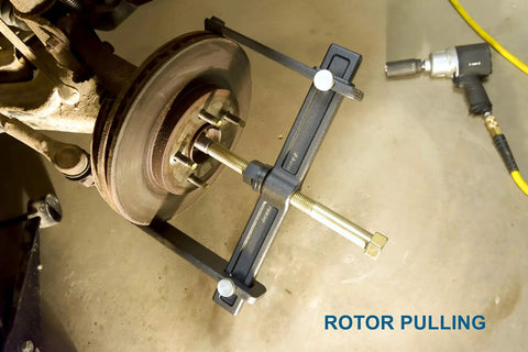 Heavy Duty Hub Drum And Rotor Puller Kit For Impact Wrench Removal in use on brake rotor showing forged construction.